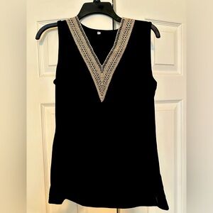Black sleeveless v neck top with tan trim